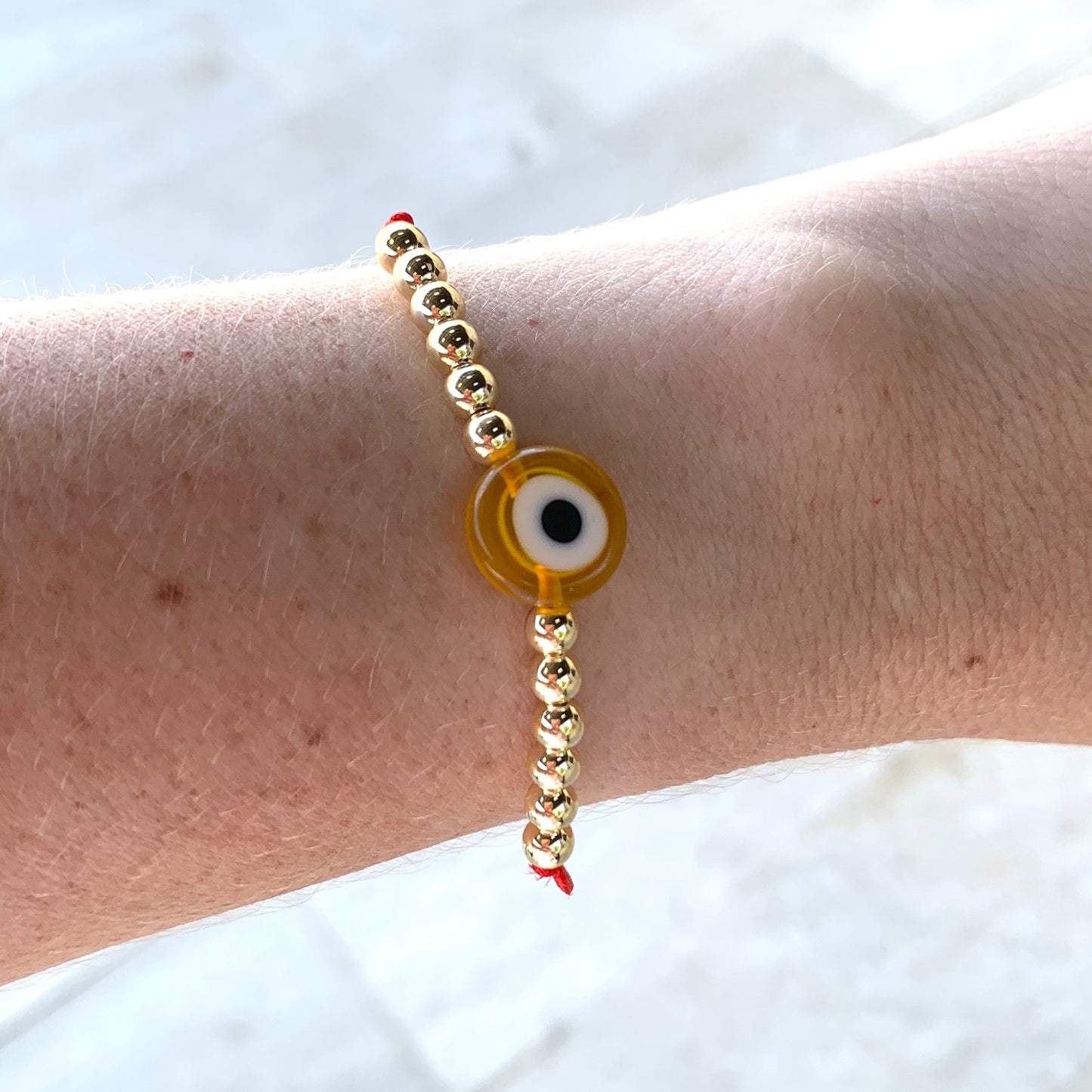 Pulseras con OJITO y bolitas doradas