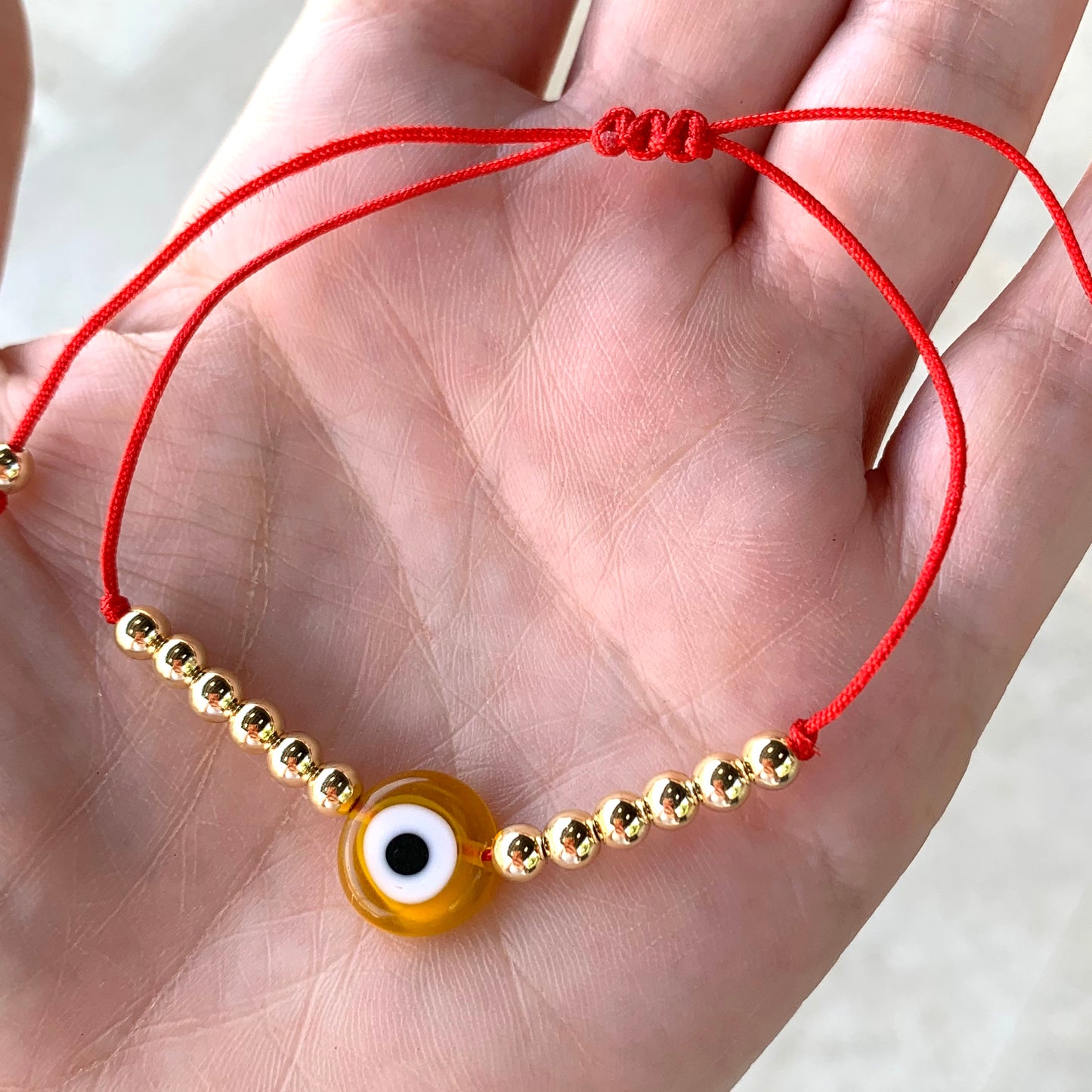 Pulseras con OJITO y bolitas doradas