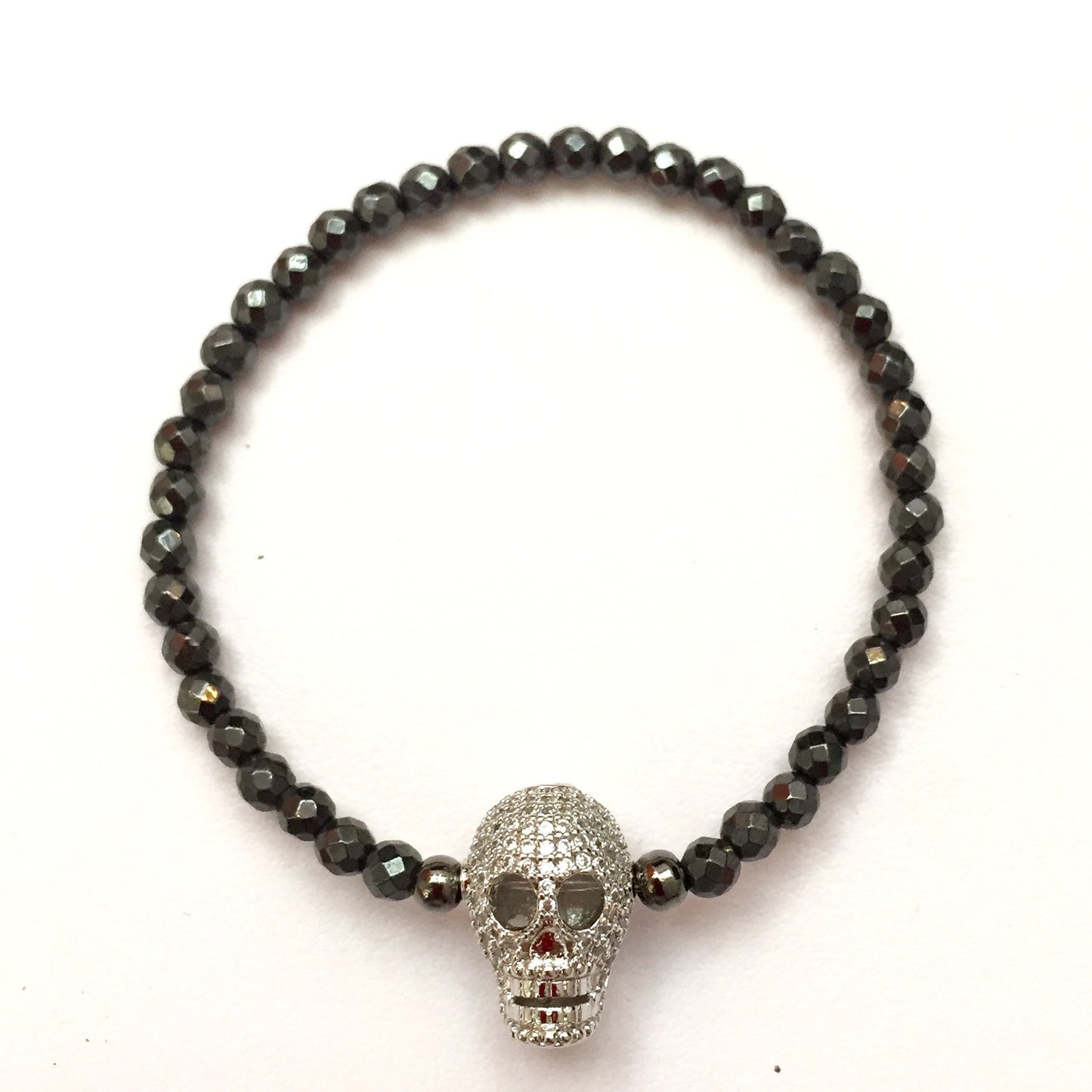 Pulsera de piedra HEMATITA con dije de CALAVERA