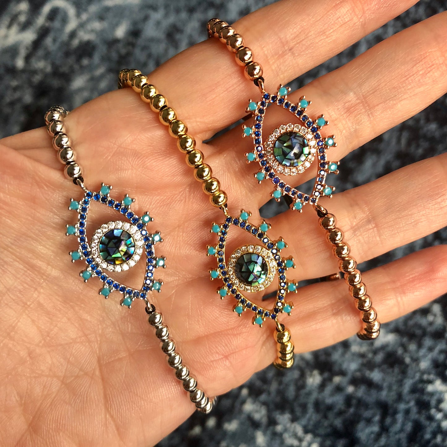 Pulseras AJUSTABLES de bolitas de ACERO INOXIDABLE con OJO de ABULON y PESTAÑAS