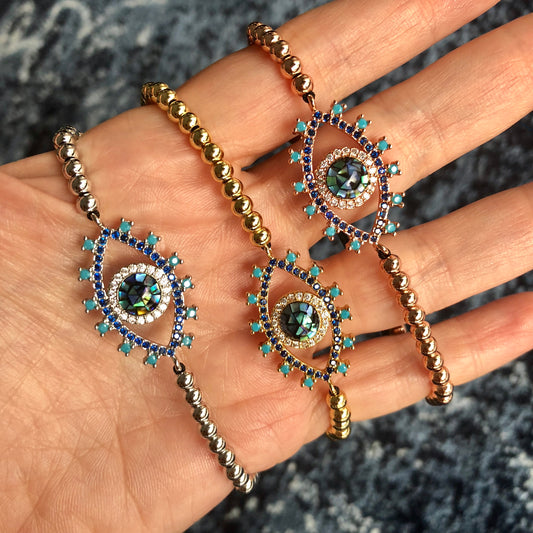 Pulseras AJUSTABLES de bolitas de ACERO INOXIDABLE con OJO de ABULON y PESTAÑAS